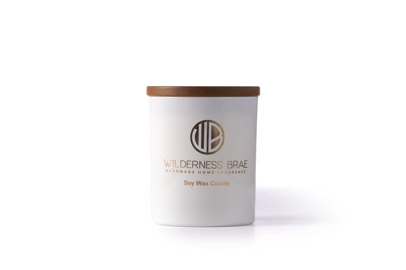 white jar candle with wooden lid on white background
