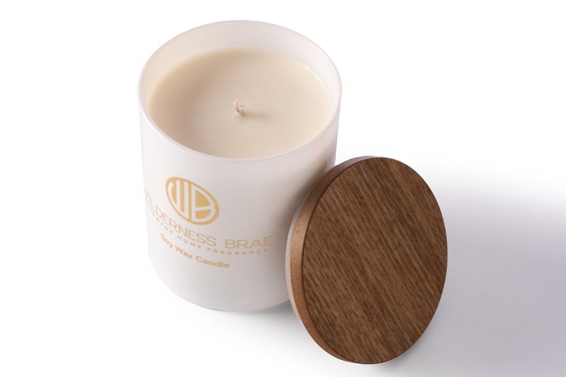 Hush of the Glen soy candle shot from above, wooden lid resting against it