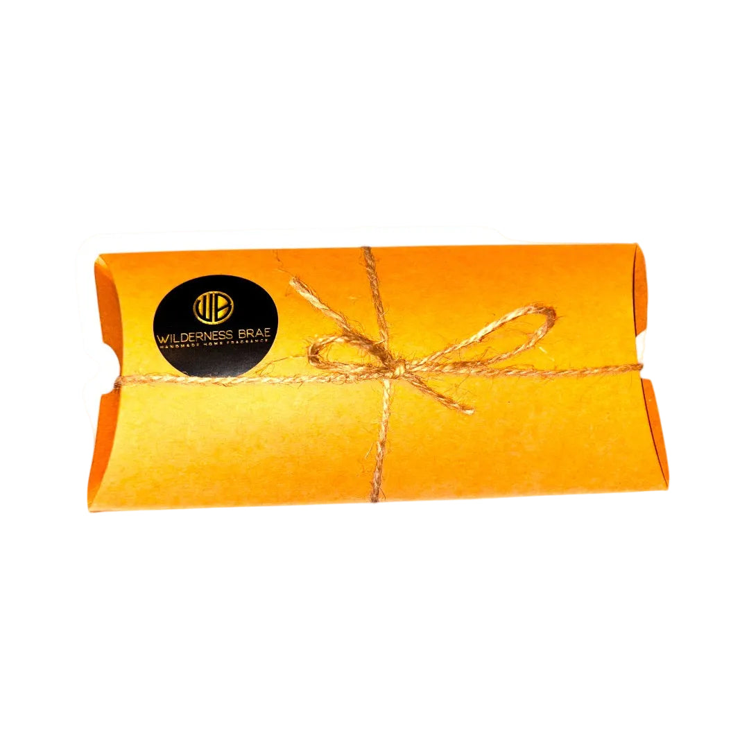 Lowland Veil soy wax melts with twine bow and 'Wilderness Brae' Handcrafted in Scotland logo on them on white background