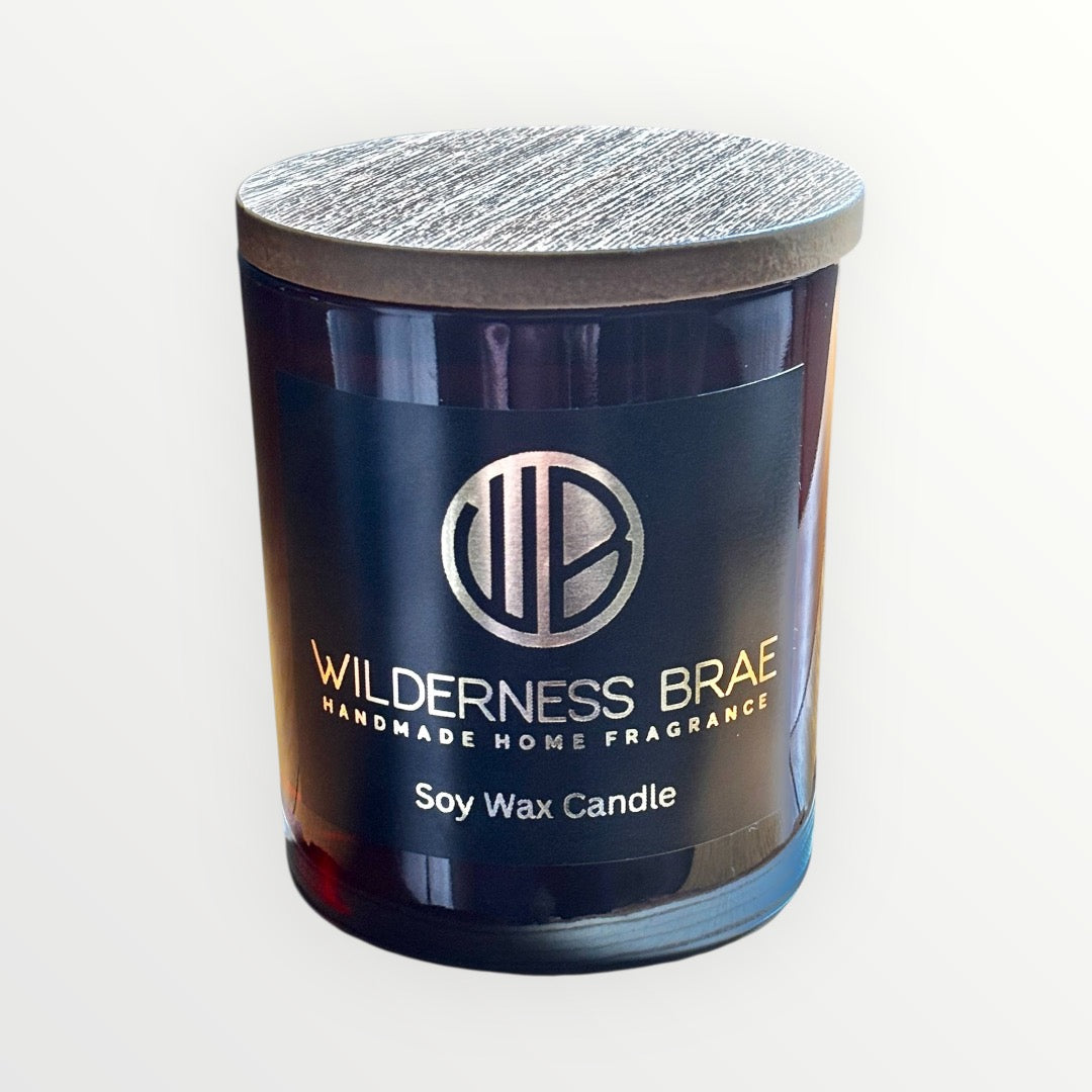 Soy wax candle in a blue jar with a silver lid on a white background