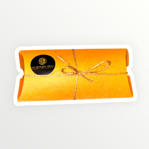 Kraft gift box with a bow and 'Wilderness Bar' logo on a white background