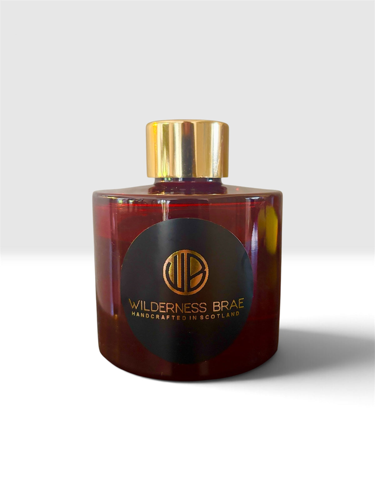 Snowberry Glen diffuser bottle by  Wilderness Brae Handcrafted in Scotland fragrance with gold cap on white background.  