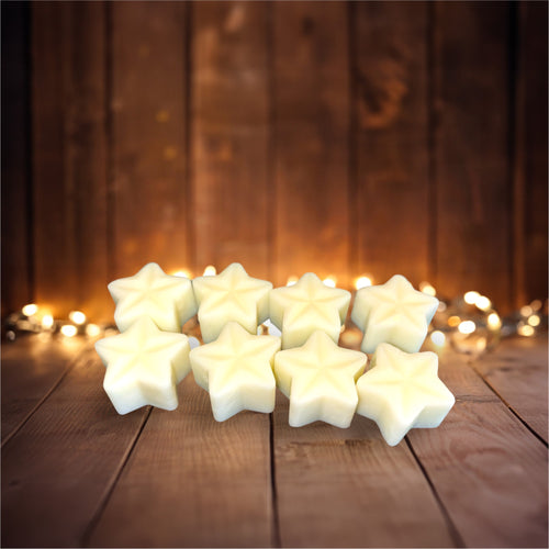 Snowberry Glen soy wax melts by Wilderness Brae 8 star shaped cream melts on wooden background and fairy lights