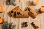 Coorie In wax melt bundle of 3 wilderness brae wax melts on a light brown cloth with pinecones, and eucalyptus sprigs.
